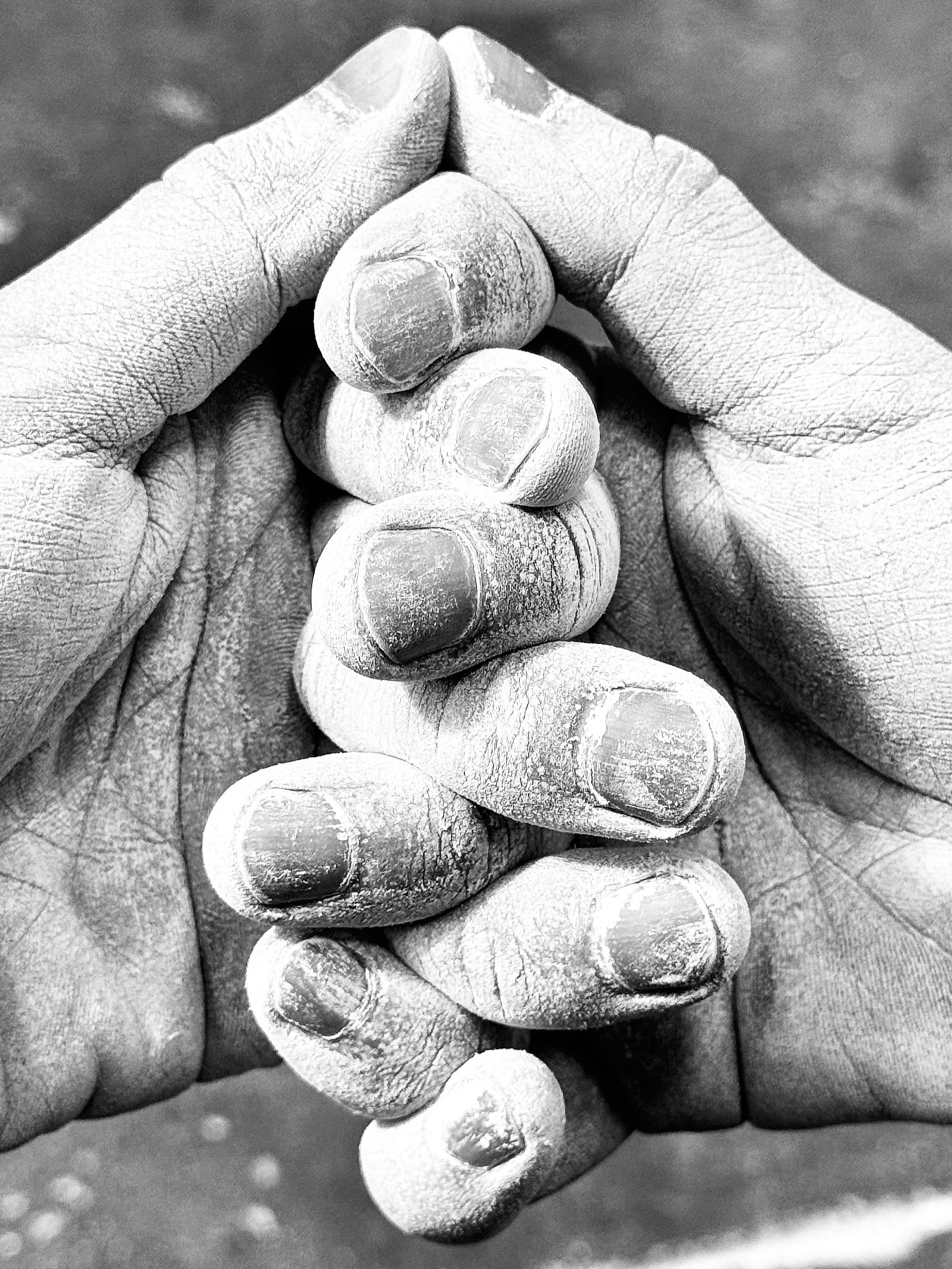 Chalked hands gripping a bar